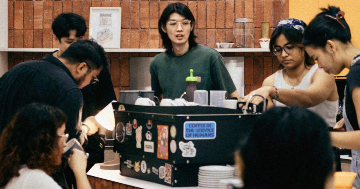 Baristas and customers inside Rookie's Coffee Shop